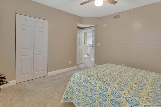 bedroom featuring a ceiling fan, a closet, visible vents, baseboards, and light colored carpet