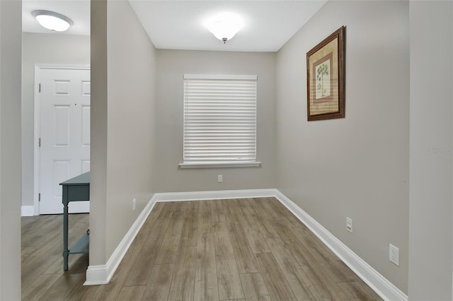 interior space with wood finished floors and baseboards