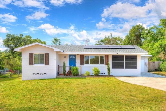 ranch-style house featuring solar panels and roof with shingles