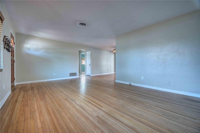 spare room with light wood-type flooring and baseboards