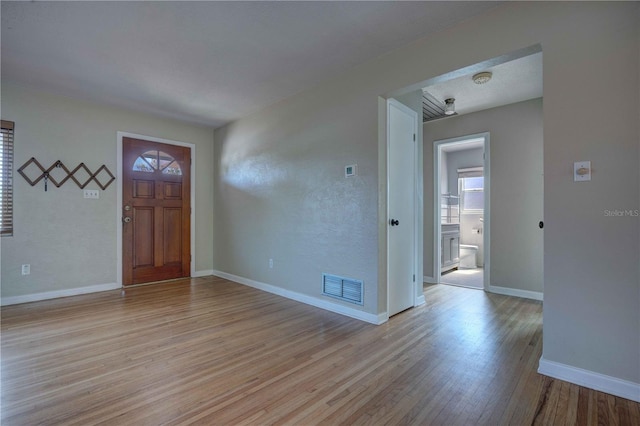 entrance foyer with light wood finished floors and baseboards