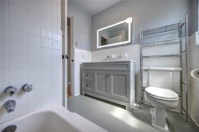 full bath with tile walls, tile patterned floors, a bathtub, vanity, and a shower