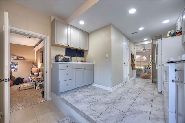 kitchen featuring ceiling fan, light marble finish floors, baseboards, recessed lighting, and light countertops