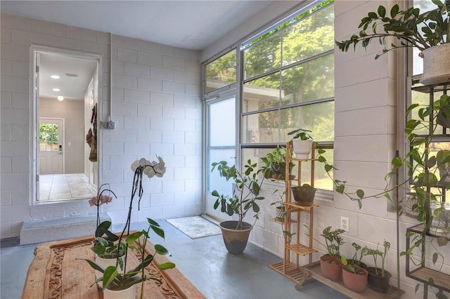 sunroom / solarium featuring healthy amount of natural light