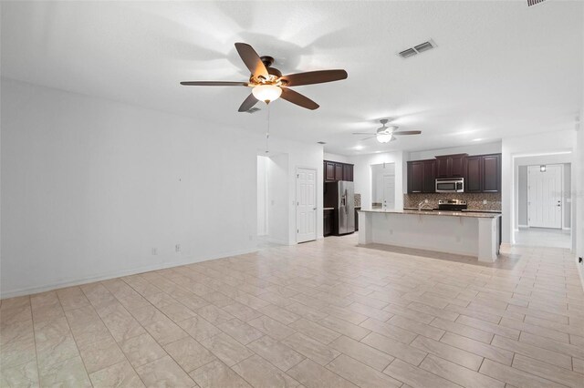 1480 Leitrim Loop, Apopka, FL 32703 - unfurnished living room with visible vents, baseboards, ceiling fan, and a sink