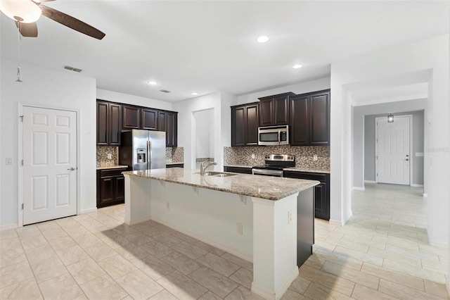 1480 Leitrim Loop, Apopka, FL 32703 - kitchen with a ceiling fan, a sink, visible vents, appliances with stainless steel finishes, and decorative backsplash