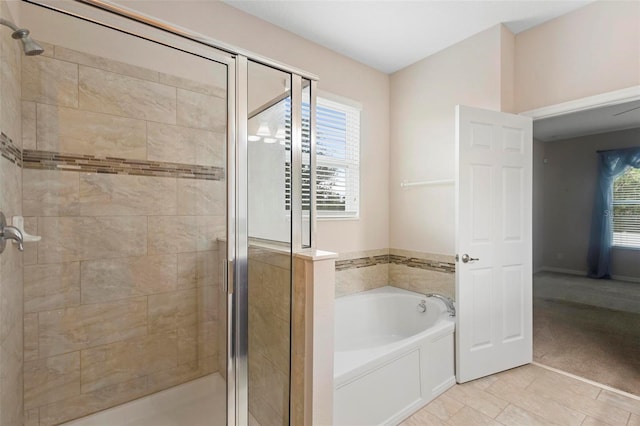 1480 Leitrim Loop, Apopka, FL 32703 - bathroom with plenty of natural light, a shower stall, a bath, and tile patterned floors