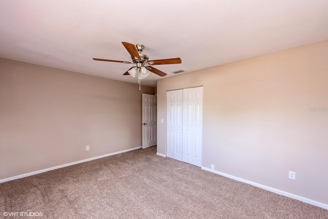 unfurnished bedroom with carpet, visible vents, baseboards, and a closet