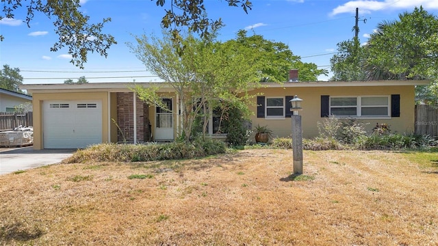 ranch-style house with concrete driveway and a garage