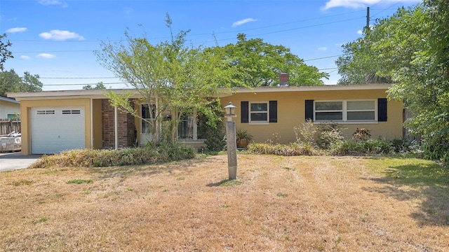 ranch-style home with an attached garage, concrete driveway, a front yard, and stucco siding