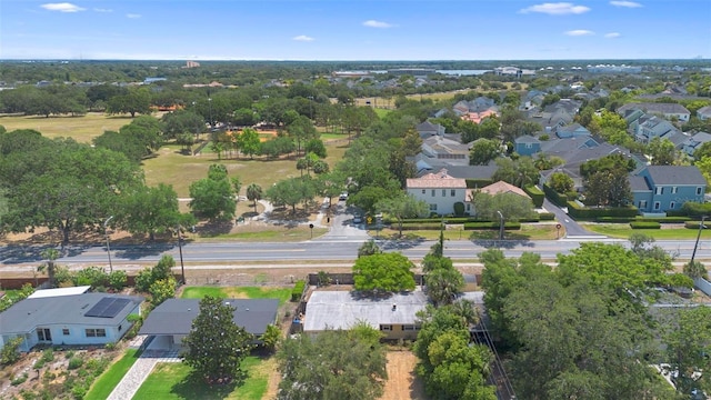 aerial view of residential area featuring a tree filled landscape