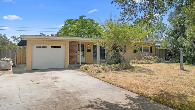 ranch-style home featuring a garage and driveway