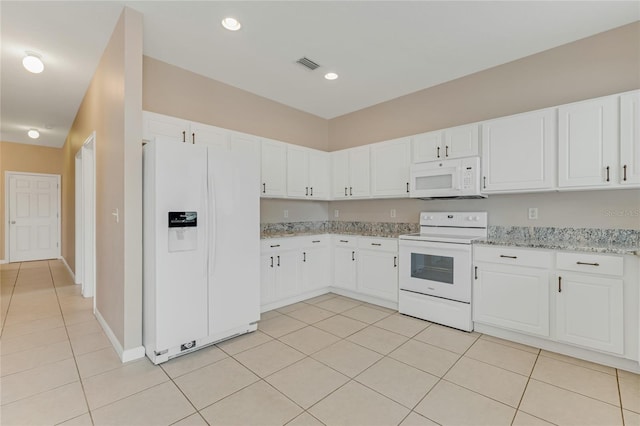 kitchen with white appliances, light tile patterned floors, white cabinetry, light stone counters, and recessed lighting
