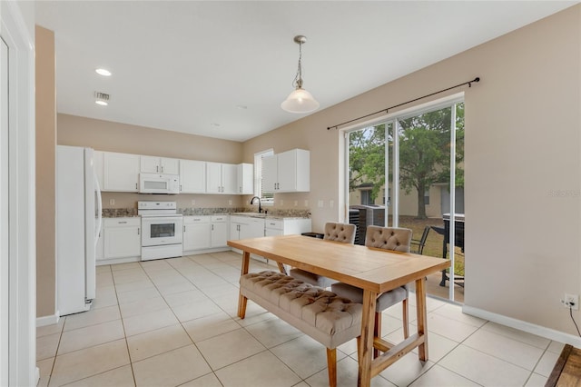dining area with baseboards and light tile patterned floors