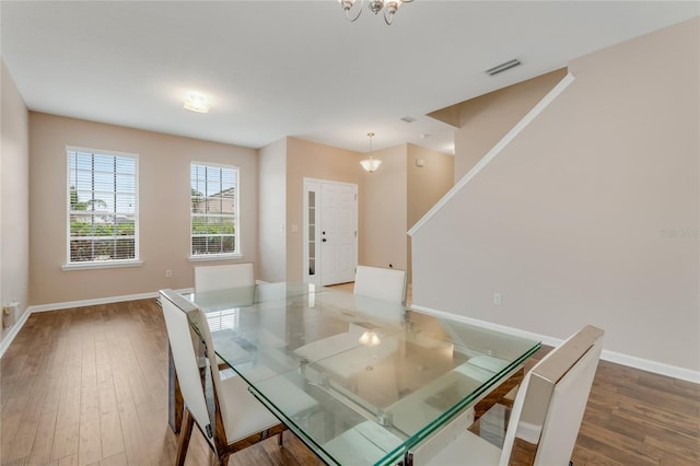 unfurnished dining area featuring wood finished floors and baseboards
