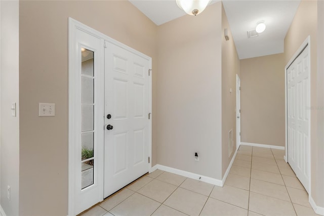 entryway featuring light tile patterned floors and baseboards