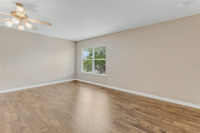 unfurnished room with light wood-type flooring, baseboards, and ceiling fan