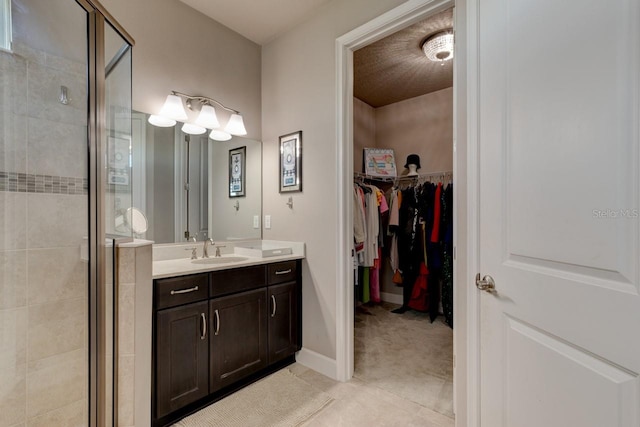 133 Azure Mist Way, Daytona Beach, FL 32124 - bathroom with a shower stall, vanity, a spacious closet, and tile patterned floors