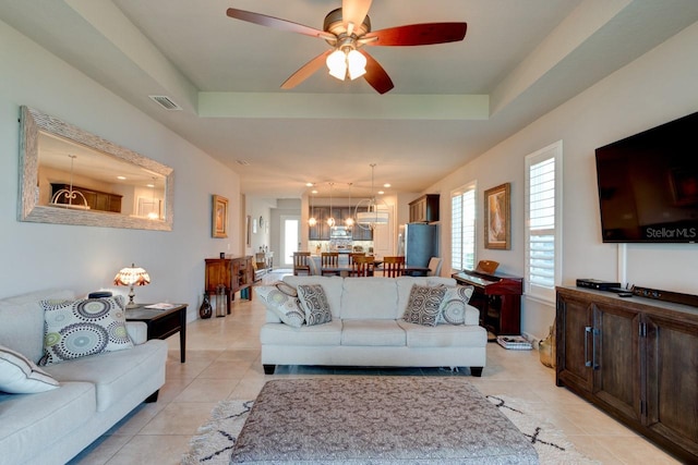 133 Azure Mist Way, Daytona Beach, FL 32124 - living area with ceiling fan, a chandelier, light tile patterned floors, and a tray ceiling