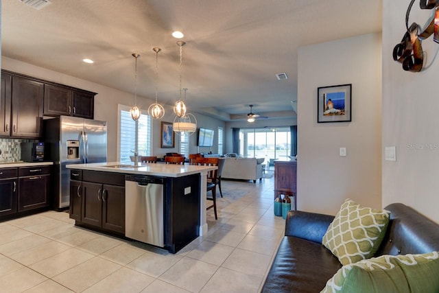 133 Azure Mist Way, Daytona Beach, FL 32124 - kitchen with stainless steel appliances, open floor plan, light tile patterned floors, light countertops, and dark brown cabinetry