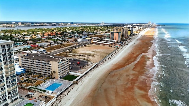 view of urban area featuring unending shoreline and a pool area
