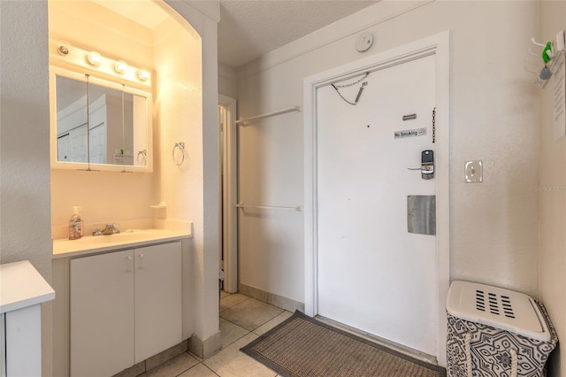 bathroom with tile patterned flooring and vanity