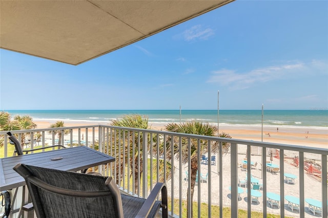 balcony featuring view of water and beach