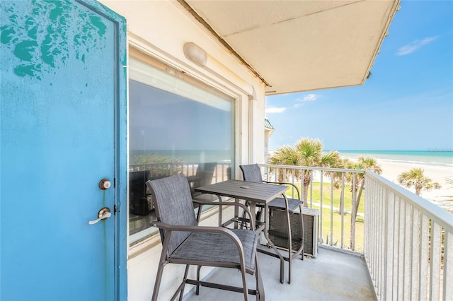 balcony featuring view of water and beach