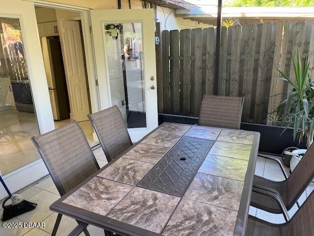 908 Boulder Dr, South Daytona, FL 32119 - view of patio featuring outdoor dining area and fence