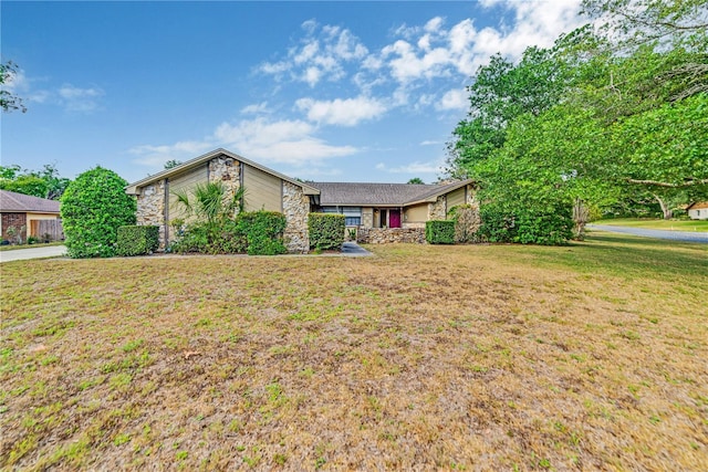 2704 Burgoyne Pl, Deland, FL 32720 - mid-century modern home with stone siding and a front lawn
