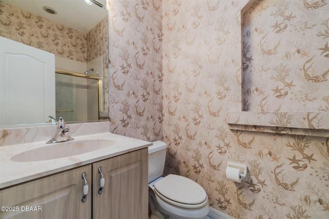 3601 Galway Ln, Ormond Beach, FL 32174 - bathroom featuring toilet, an enclosed shower, vanity, and wallpapered walls