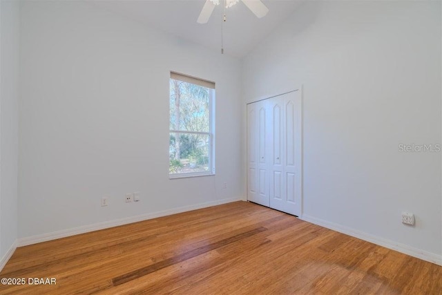 3601 Galway Ln, Ormond Beach, FL 32174 - unfurnished room featuring light wood-type flooring, baseboards, ceiling fan, and high vaulted ceiling