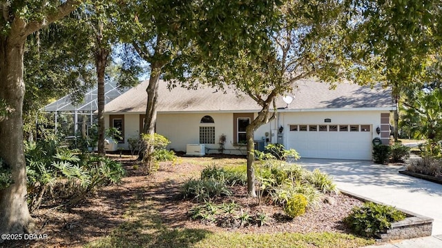 3601 Galway Ln, Ormond Beach, FL 32174 - ranch-style home featuring a garage, concrete driveway, stucco siding, a lanai, and a shingled roof