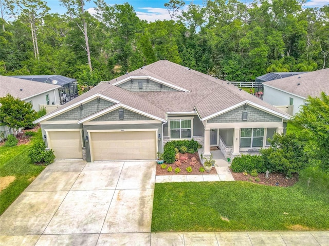 409 Nowell Loop, Deland, FL 32724 - view of front facade with a garage, concrete driveway, a front lawn, stone siding, and stucco siding