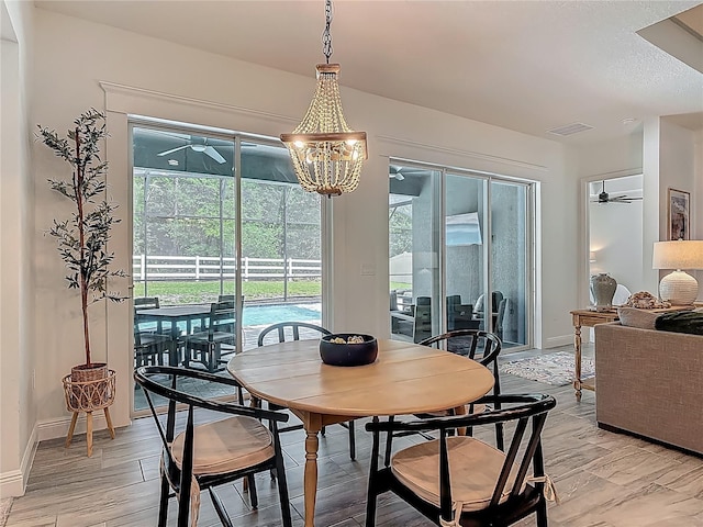 409 Nowell Loop, Deland, FL 32724 - dining room featuring a ceiling fan, baseboards, and light wood-style flooring