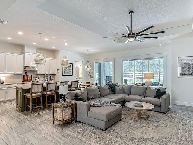 409 Nowell Loop, Deland, FL 32724 - living area with a textured ceiling, recessed lighting, ceiling fan, and baseboards