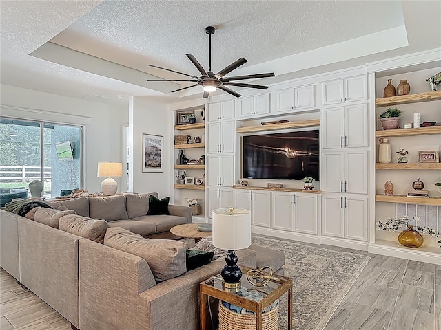 409 Nowell Loop, Deland, FL 32724 - living area featuring a textured ceiling, a ceiling fan, and light wood finished floors