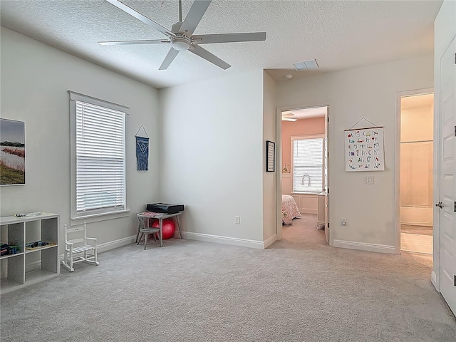 409 Nowell Loop, Deland, FL 32724 - carpeted bedroom with a textured ceiling, baseboards, and a ceiling fan