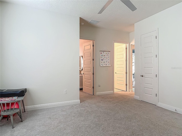 409 Nowell Loop, Deland, FL 32724 - carpeted bedroom with a textured ceiling, baseboards, and ceiling fan