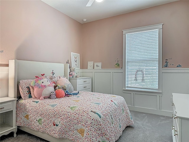 409 Nowell Loop, Deland, FL 32724 - carpeted bedroom featuring a decorative wall, a wainscoted wall, and ceiling fan