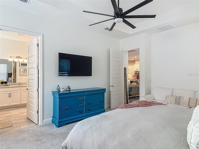 409 Nowell Loop, Deland, FL 32724 - bedroom featuring ensuite bath, ceiling fan, light carpet, and baseboards