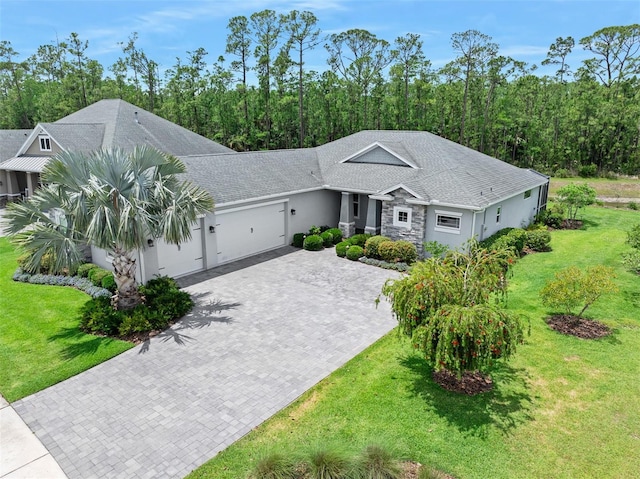 3322 Modena Way, New Smyrna Beach, FL 32168 - ranch-style house featuring an attached garage, driveway, stone siding, and a front yard