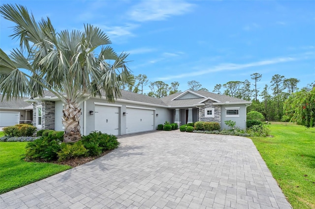 3322 Modena Way, New Smyrna Beach, FL 32168 - ranch-style house with stone siding, a garage, decorative driveway, a front yard, and stucco siding