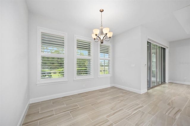 3322 Modena Way, New Smyrna Beach, FL 32168 - unfurnished room featuring a chandelier and baseboards