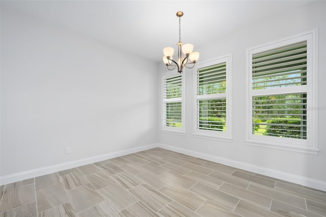 3322 Modena Way, New Smyrna Beach, FL 32168 - empty room with a chandelier, plenty of natural light, and baseboards