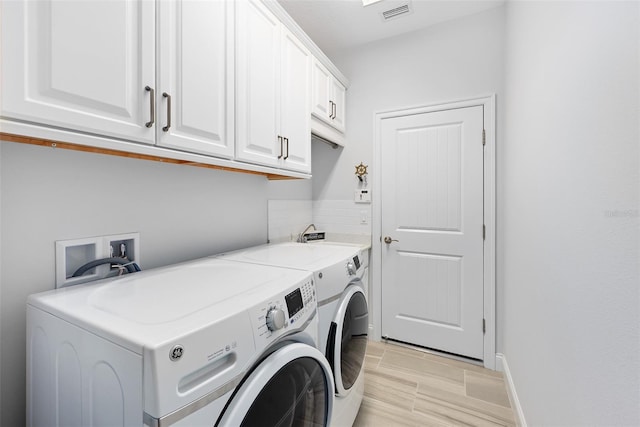 3322 Modena Way, New Smyrna Beach, FL 32168 - laundry room featuring cabinet space, separate washer and dryer, and baseboards
