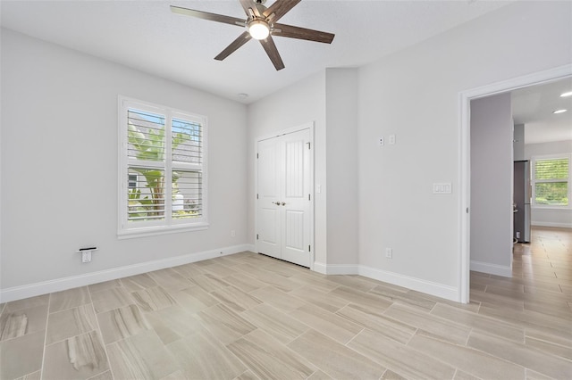 3322 Modena Way, New Smyrna Beach, FL 32168 - unfurnished bedroom featuring baseboards, a ceiling fan, and a closet