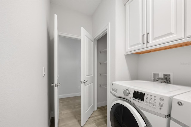 3322 Modena Way, New Smyrna Beach, FL 32168 - clothes washing area with cabinet space, washer and dryer, and baseboards
