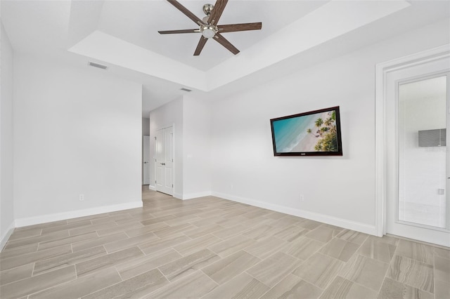 3322 Modena Way, New Smyrna Beach, FL 32168 - unfurnished room with a ceiling fan, a raised ceiling, and baseboards