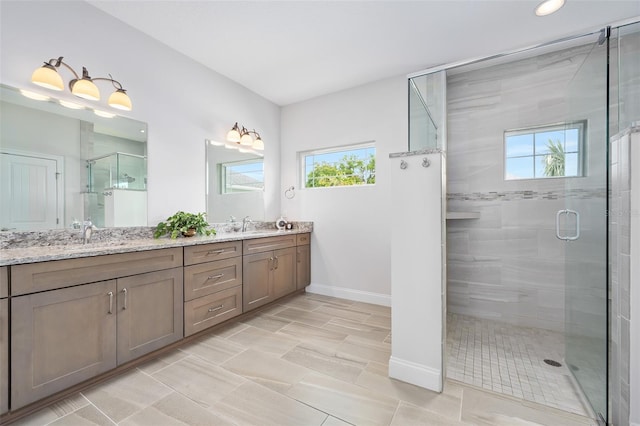 3322 Modena Way, New Smyrna Beach, FL 32168 - full bath with plenty of natural light, a shower stall, double vanity, baseboards, and recessed lighting
